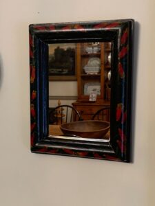 small antique red trumpet painted flower mirror.